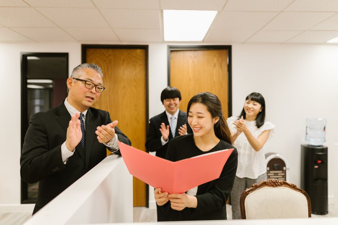 Colleagues celebrating a professional promotion at work