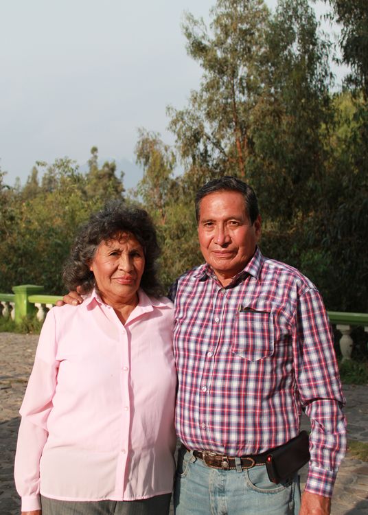 An older couple standing together outdoors